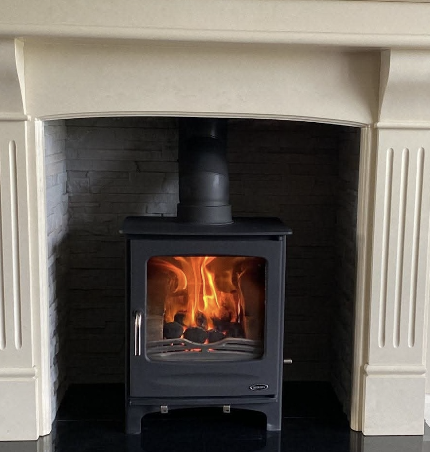 Cream mantel alcove with cast iron stove