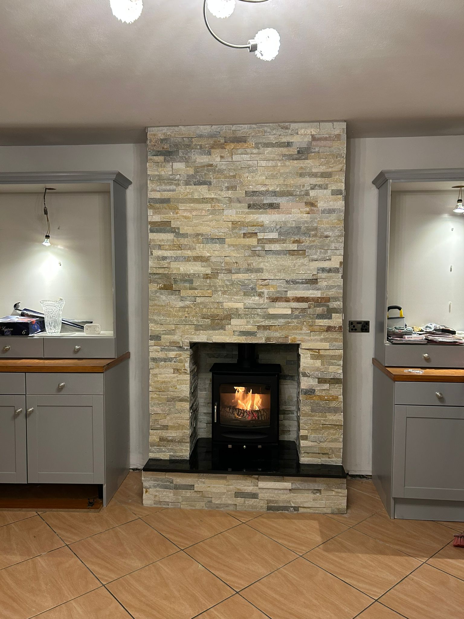 Alcove fitting with white ornate mantel and black stove
