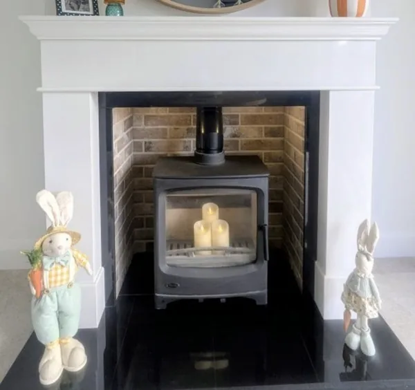 White mantel alcove with brick interior