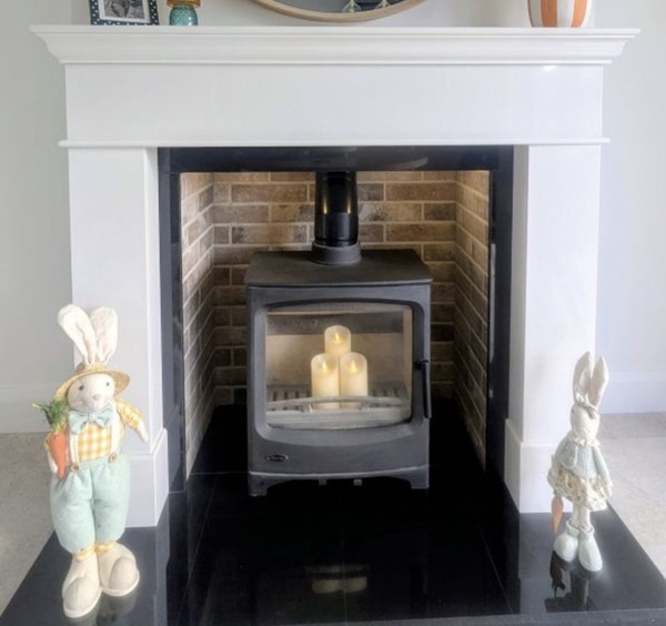 White mantel alcove with brick interior